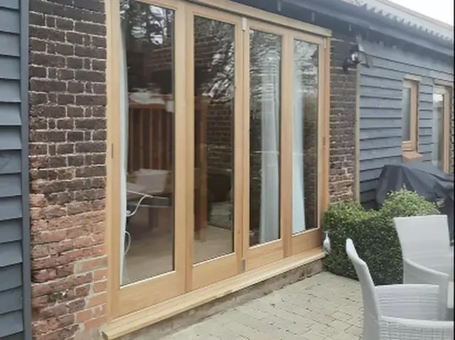 Light oak glazed doors opening onto a patio